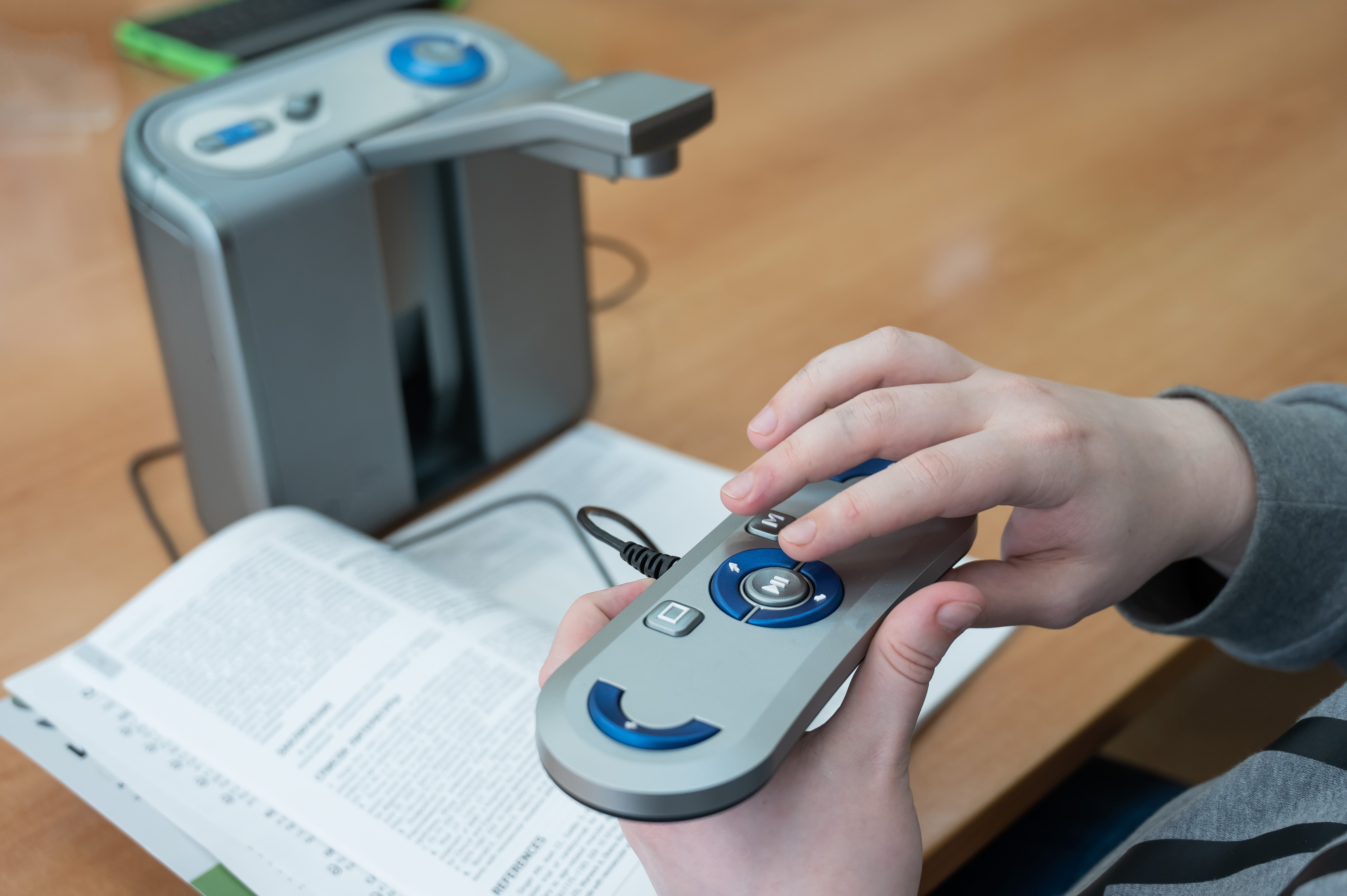 Hands holding a text to voice reader interface